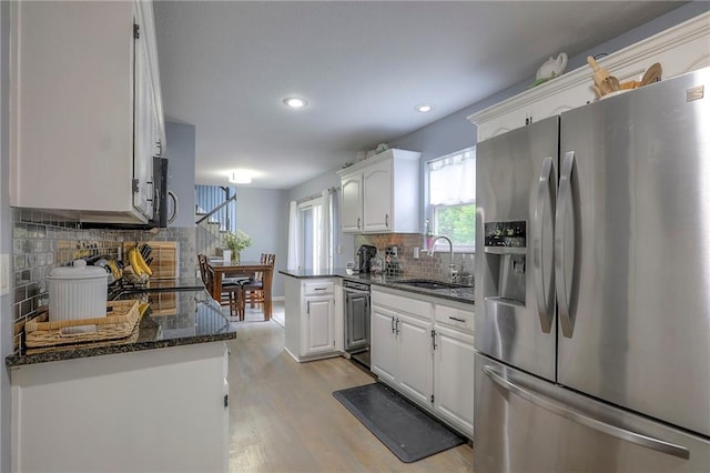 503 SW Creek Ridge Dr, Grain Valley, MO 64029 - kitchen featuring stainless steel fridge with ice dispenser, white cabinets, tasteful backsplash, light wood finished floors, and recessed lighting