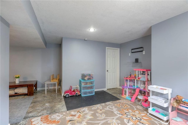 503 SW Creek Ridge Dr, Grain Valley, MO 64029 - rec room with a textured ceiling and concrete floors