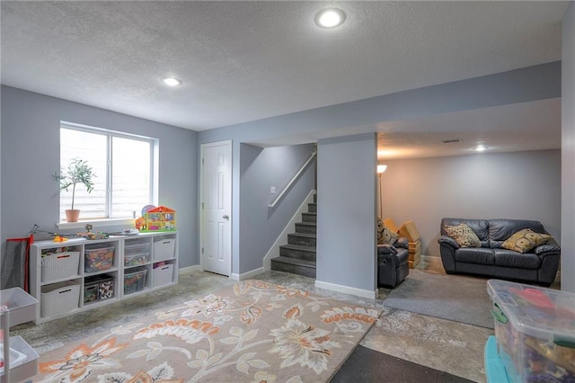 503 SW Creek Ridge Dr, Grain Valley, MO 64029 - below grade area with stairway, a textured ceiling, and recessed lighting
