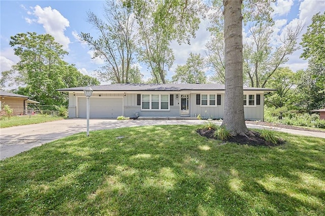 7725 Cleveland Ave, Kansas City, KS 66109 - single story home featuring board and batten siding, an attached garage, concrete driveway, and a front lawn
