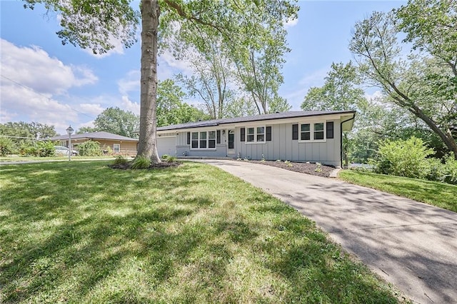 7725 Cleveland Ave, Kansas City, KS 66109 - ranch-style home featuring board and batten siding, concrete driveway, a front lawn, and an attached garage