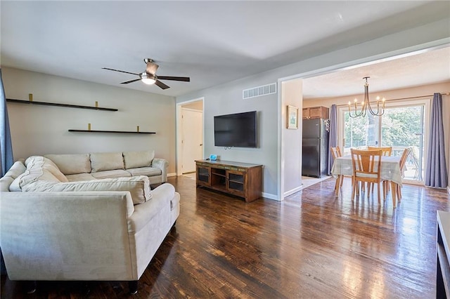 7725 Cleveland Ave, Kansas City, KS 66109 - living area with a chandelier, dark wood-style flooring, and a ceiling fan