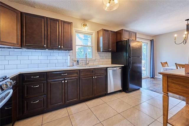 7725 Cleveland Ave, Kansas City, KS 66109 - kitchen featuring stainless steel appliances, light countertops, healthy amount of natural light, a textured ceiling, and backsplash
