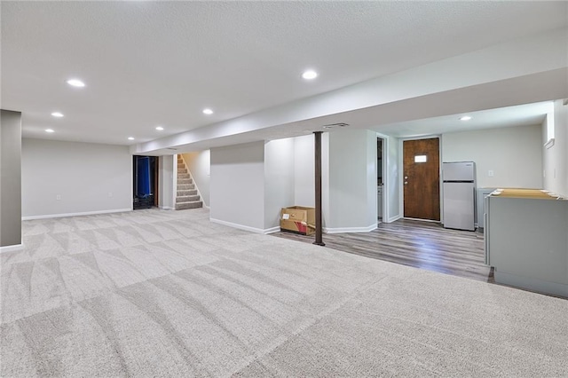 7725 Cleveland Ave, Kansas City, KS 66109 - finished below grade area featuring freestanding refrigerator, light colored carpet, stairs, and recessed lighting