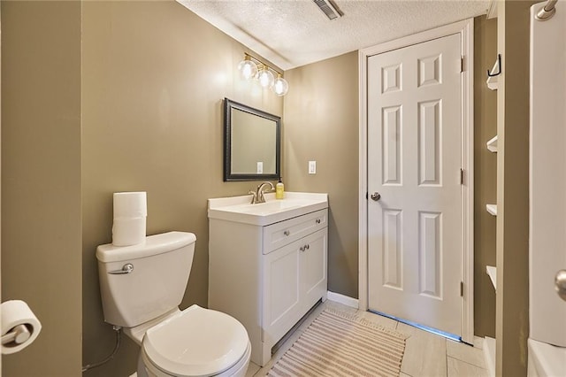 7725 Cleveland Ave, Kansas City, KS 66109 - bathroom with a textured ceiling, vanity, and tile patterned flooring