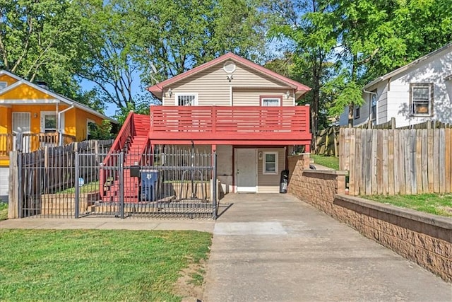 3021 Topping Ave, Kansas City, MO 64129 - view of front of home with a deck, stairway, and concrete driveway