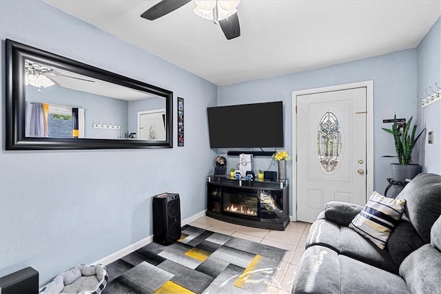 3021 Topping Ave, Kansas City, MO 64129 - tiled living room with a ceiling fan and a glass covered fireplace
