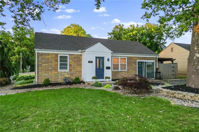 3600 NE 52nd Ter, Kansas City, MO 64119 - view of front of home with stone siding, a front yard, and roof with shingles