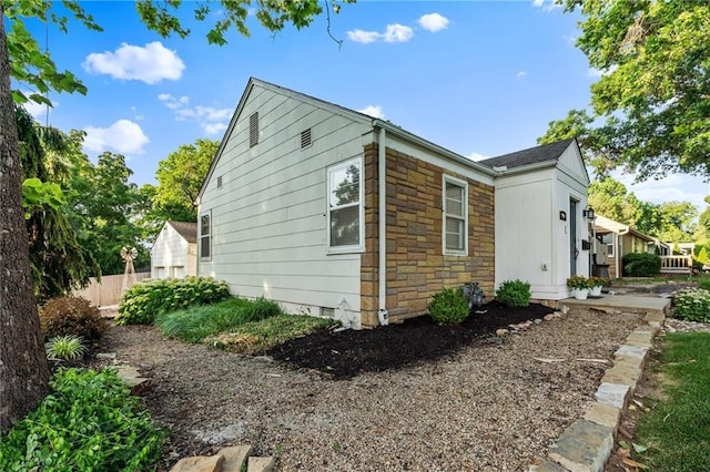 3600 NE 52nd Ter, Kansas City, MO 64119 - view of side of home with stone siding and crawl space