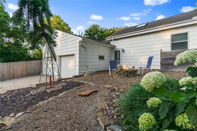 3600 NE 52nd Ter, Kansas City, MO 64119 - rear view of property featuring driveway and a fire pit