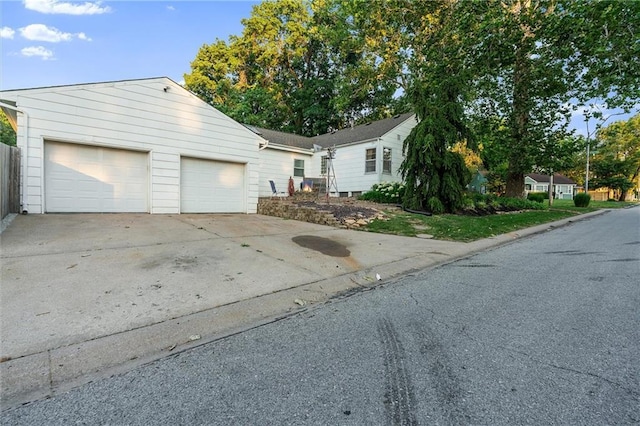 3600 NE 52nd Ter, Kansas City, MO 64119 - ranch-style house with concrete driveway and an attached garage