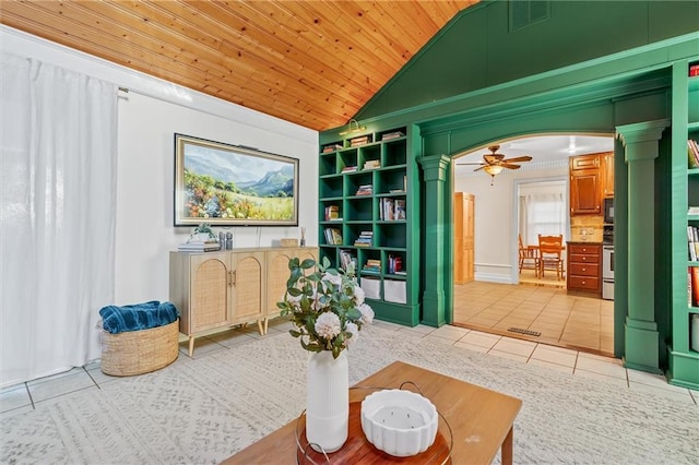 3600 NE 52nd Ter, Kansas City, MO 64119 - living area with decorative columns, light tile patterned flooring, vaulted ceiling, wood ceiling, and a ceiling fan