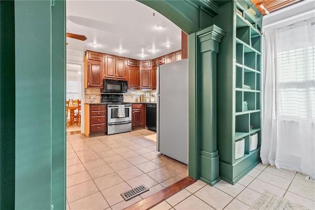 3600 NE 52nd Ter, Kansas City, MO 64119 - kitchen featuring black appliances, light tile patterned floors, dark countertops, tasteful backsplash, and arched walkways