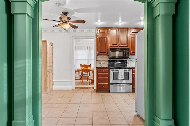 3600 NE 52nd Ter, Kansas City, MO 64119 - kitchen with stainless steel range with electric stovetop, black microwave, ceiling fan, light tile patterned floors, and tasteful backsplash