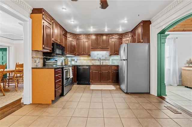 3600 NE 52nd Ter, Kansas City, MO 64119 - kitchen with black appliances, light tile patterned floors, backsplash, dark countertops, and recessed lighting
