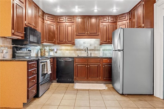 3600 NE 52nd Ter, Kansas City, MO 64119 - kitchen featuring black appliances, decorative backsplash, light tile patterned floors, and brown cabinetry