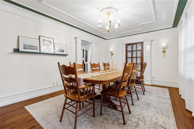 3600 NE 52nd Ter, Kansas City, MO 64119 - dining space with a chandelier, wood finished floors, a tray ceiling, and crown molding