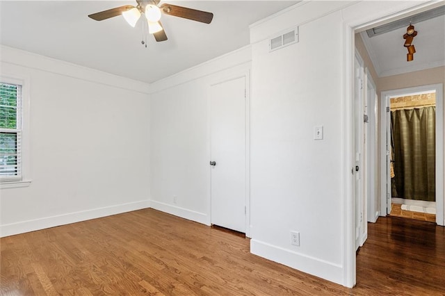 3600 NE 52nd Ter, Kansas City, MO 64119 - unfurnished bedroom with crown molding, wood finished floors, and a ceiling fan