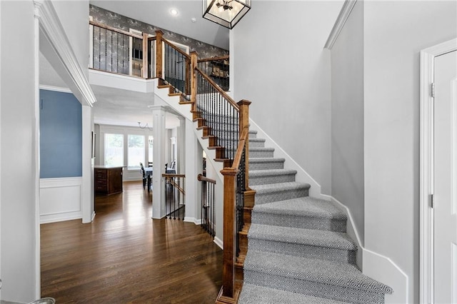 14920 S Roxburghe St, Olathe, KS 66061 - stairs featuring wood finished floors, ornate columns, and crown molding
