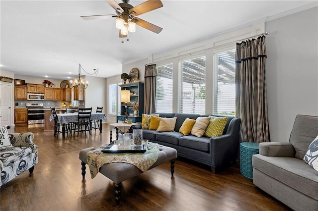14920 S Roxburghe St, Olathe, KS 66061 - living room with a chandelier, ceiling fan, dark wood-style flooring, and ornamental molding