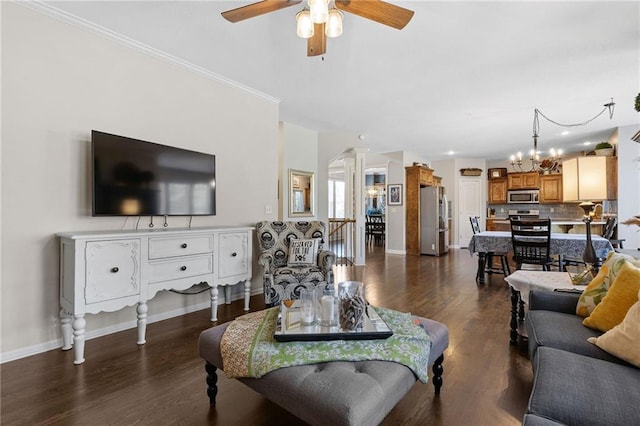 14920 S Roxburghe St, Olathe, KS 66061 - living room with ceiling fan, a chandelier, dark wood-type flooring, ornate columns, and crown molding