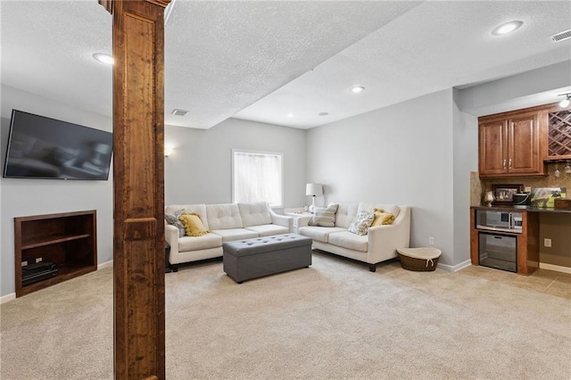 14920 S Roxburghe St, Olathe, KS 66061 - living room featuring light carpet, a textured ceiling, decorative columns, bar, and recessed lighting