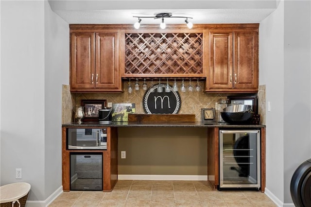 14920 S Roxburghe St, Olathe, KS 66061 - indoor wet bar with wine cooler, stainless steel microwave, tasteful backsplash, and light tile patterned flooring