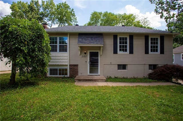 19707 E 14th St, Independence, MO 64056 - split foyer home with a front yard and a chimney