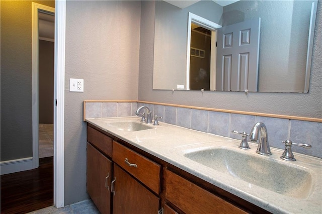 19707 E 14th St, Independence, MO 64056 - full bath featuring double vanity, a textured wall, and tasteful backsplash