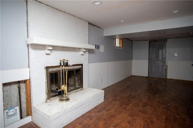 19707 E 14th St, Independence, MO 64056 - finished basement featuring a wainscoted wall, wood finished floors, and a brick fireplace