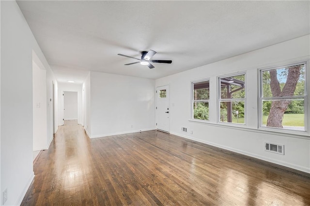 7909 Arnote Rd, Pleasant Valley, MO 64068 - unfurnished living room featuring wood finished floors and ceiling fan