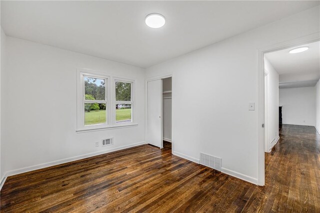 7909 Arnote Rd, Pleasant Valley, MO 64068 - unfurnished bedroom with dark wood-style flooring and a closet