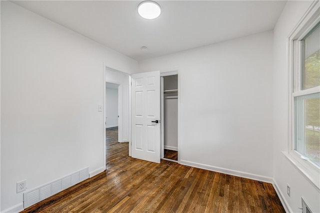 7909 Arnote Rd, Pleasant Valley, MO 64068 - unfurnished bedroom with dark wood finished floors and a closet