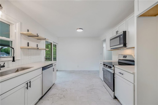 7909 Arnote Rd, Pleasant Valley, MO 64068 - kitchen with appliances with stainless steel finishes, open shelves, light marble finish flooring, backsplash, and light countertops