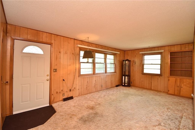 16210 Baxter Rd, Excelsior Springs, MO 64024 - carpeted entryway with a textured ceiling and wooden walls