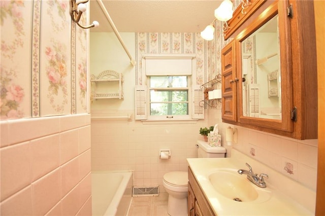 16210 Baxter Rd, Excelsior Springs, MO 64024 - full bathroom with tile patterned floors, a bathtub, tile walls, vanity, and wainscoting