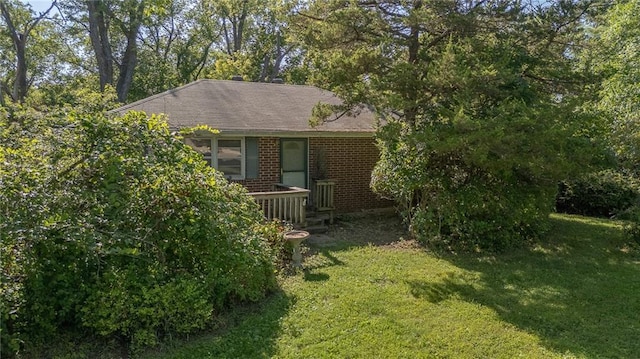 16210 Baxter Rd, Excelsior Springs, MO 64024 - view of home's exterior with a lawn and brick siding
