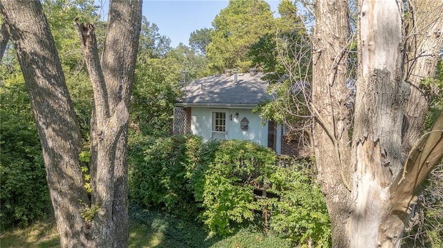 16210 Baxter Rd, Excelsior Springs, MO 64024 - view of side of property with brick siding and roof with shingles