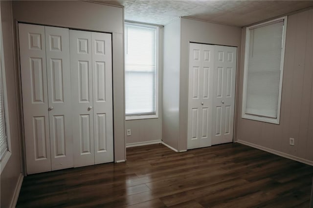 2603 Patee St, Saint Joseph, MO 64507 - unfurnished bedroom featuring dark wood-style flooring and multiple closets
