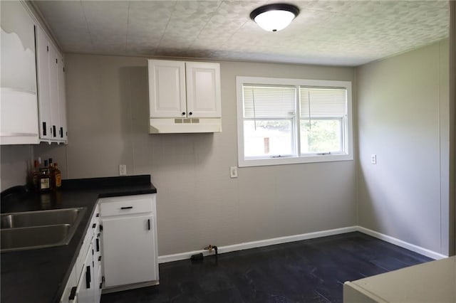 2603 Patee St, Saint Joseph, MO 64507 - kitchen with dark wood-style flooring, white cabinetry, and dark countertops