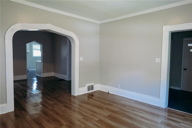 2603 Patee St, Saint Joseph, MO 64507 - unfurnished room with dark wood-style flooring, arched walkways, and ornamental molding