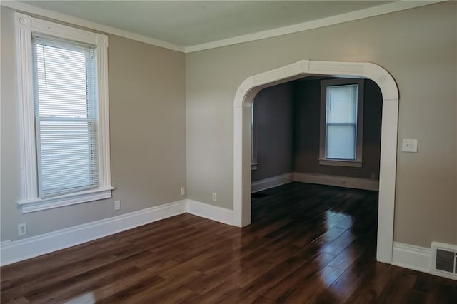2603 Patee St, Saint Joseph, MO 64507 - empty room featuring dark wood-style flooring, crown molding, and arched walkways