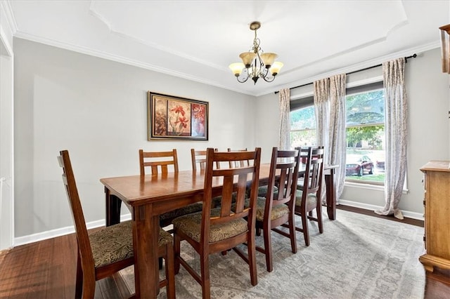 15820 W 150th Ter, Olathe, KS 66062 - dining space with a chandelier, a tray ceiling, wood finished floors, and crown molding