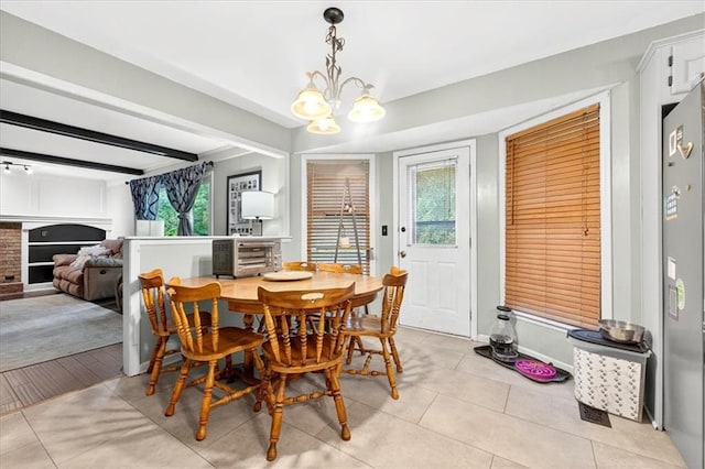 15820 W 150th Ter, Olathe, KS 66062 - dining room featuring a chandelier, light tile patterned floors, and beam ceiling