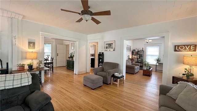 309 College St, Paola, KS 66071 - living area with ceiling fan and light wood-style floors