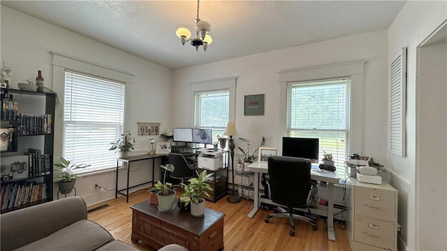 309 College St, Paola, KS 66071 - office featuring light wood finished floors and a chandelier