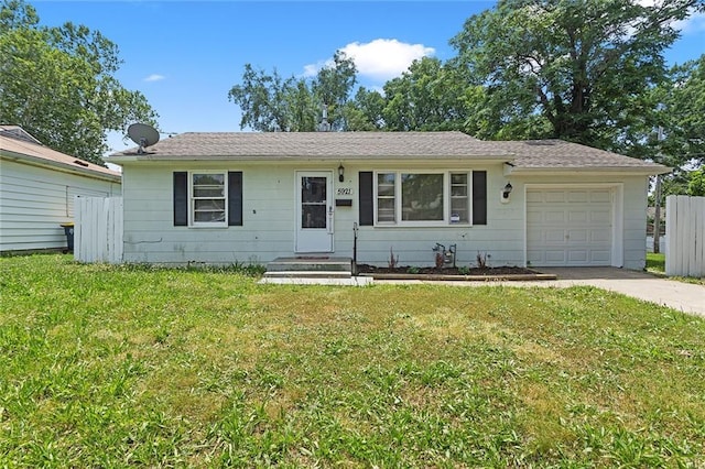 5921 Lexington Ave, Kansas City, MO 64123 - view of front of property featuring a garage and driveway
