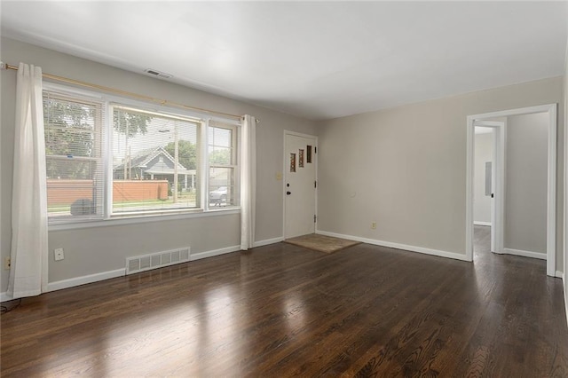 5921 Lexington Ave, Kansas City, MO 64123 - foyer entrance with dark wood-type flooring and baseboards