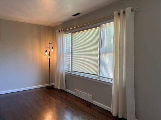 5921 Lexington Ave, Kansas City, MO 64123 - spare room with dark wood-type flooring and baseboards