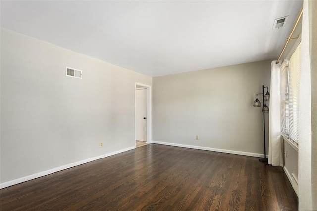 5921 Lexington Ave, Kansas City, MO 64123 - unfurnished room featuring dark wood-style flooring and baseboards